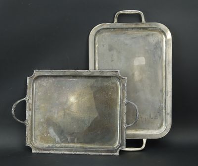 two silver trays with handles and handles on a black background
