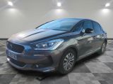 a grey car parked in a room with a checkered floor