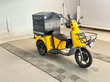 a small yellow motorcycle with a box on the back of it