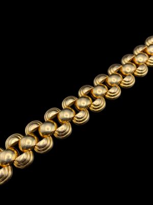 a close up of a gold chain on a black background