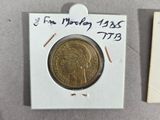 an image of a small piece of gold coin with a note attached to it