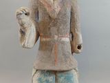 statue of a man holding a bird in his right hand