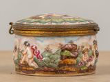 a small box with a painting on it sitting on a table