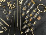 a lot of gold and silver jewelry on a table