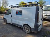a white van parked in a parking lot with other vehicles