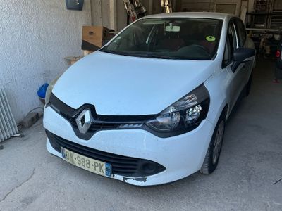the white car is parked in the garage in front of a radiator