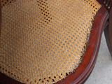 a wooden chair with a brown seat and a yellow seat pad