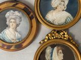 three framed portraits of women in hats and gowns hang on a wall