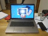 a laptop that is sitting on a desk with a cell phone