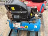 a small air compressor sitting on a pallet on a pallet