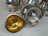 a lot of silver items that are on the table