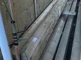 a pile of wooden planks sitting on the side of a building