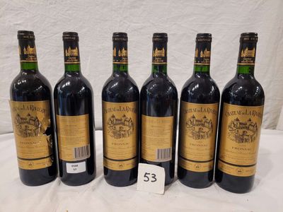 six bottles of wine are lined up on a table