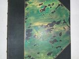a green and black book on a white table