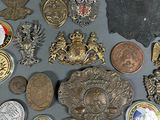 a lot of coins and badges on the table