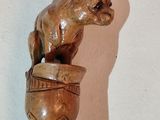 a statue of a bear sitting on top of a light bulb
