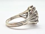 an image of a silver ring with a flower design on it