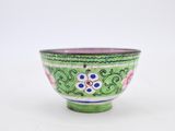 green and pink bowl with floral design on the rim
