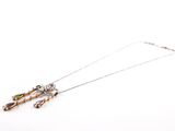 silver necklace with multi colored beads and a long chain on a white background