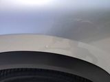 a close up of a car ' s front bumper with a hole in it