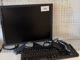 a computer monitor and keyboard sitting on a desk