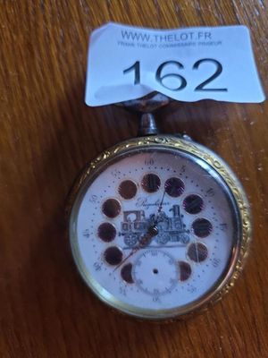 a pocket watch on a table with a price tag on it