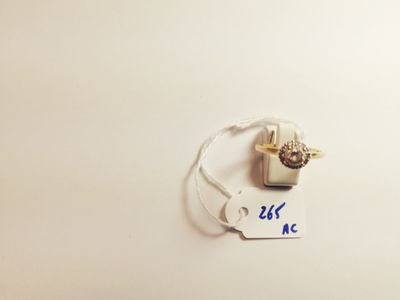 a tag with a ring attached to it on a white surface