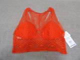 a close up of an orange bra top on a gray surface