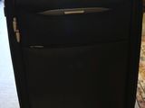 a black suitcase sitting on the floor in a room