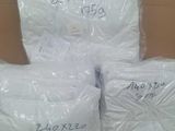 three bags of white pillows sitting on top of a cardboard box
