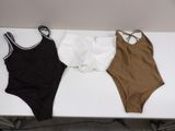 three bodysuits on a white table with a black and brown one - piece