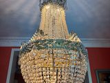 a crystal chandelier hanging from the ceiling in a room
