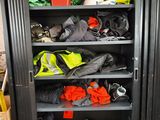 a metal cabinet filled with lots of clothes and shoes