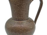 a brown vase with a handle on a white background