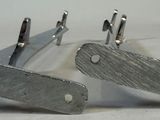 two knives that are sitting next to each other on a table