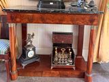 a small table with a clock on top of it