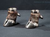 two silver cups with a bear ' s paw design on them