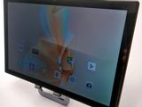 a tablet that is sitting on a stand on a table