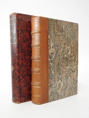 two books sitting side by side on top of a white surface