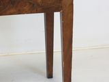 a small wooden table with a drawer on it