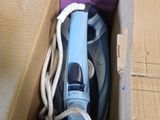 a box that has a blue and white steam iron in it
