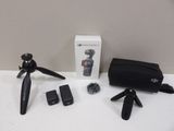a camera and a tripod sitting on a table next to a box