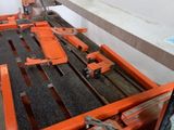 a machine that is working on a piece of wood