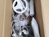 a cardboard box with a steering wheel, steering wheel, and other electronics in it