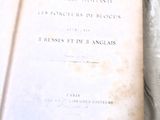 an open book on a table with a white cloth