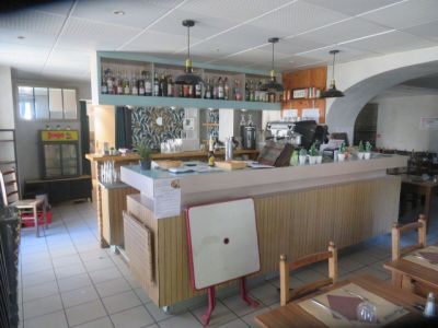 an image of a kitchen and dining room with a bar