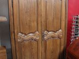 an image of a wooden armoire in a room