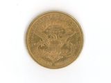a gold coin on a white surface with a white background