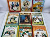 several children ' s books are lined up on a white surface