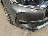 the front bumper of a car with a denting dent on it